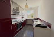 Ruhige 2-Zimmer Wohnung mit Grünblick, Terrasse + 2 Garagenplätzen