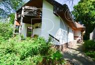 Einfamilienhaus in zentraler Bestlage mit Tennisplatz auf parkähnlichem Grund!