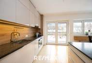 Hochwertige 3-Zimmer-Wohnung mit Tischlerküche, 160 m² Eigengarten, Terrasse und Garage in ruhiger, grüner Lage!