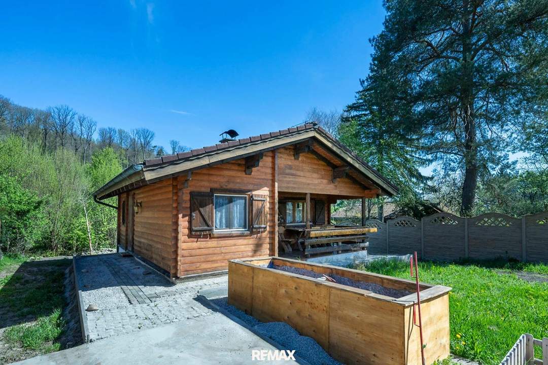 „Wohnen im Einklang mit der Natur – Stilvolles Holzhaus in traumhafter Ruhelage auf unverbaubarem Grundstück“