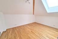 Ideal für Singles oder Paare – neuwertige Mansardenwohnung mit Balkon und Carport