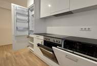 Sonnwendviertel: 1-Zimmer-Wohnung mit Balkon im 12. OG – Fitnessraum, Co-Working &amp; Rooftop-Terrasse inklusive!