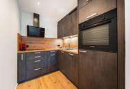 Sanierte Perle mit alpinem Flair: Exklusive 2-Zimmer-Wohnung