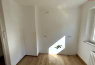 Herrlich sanierte Erdgeschosswohnung mit moderner Wohnküche, stilvollem Badezimmer und Grünblick - in ruhiger Siedlungslage mit ausgezeichneter Infrastruktur, ideal für kleine Familien!