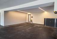 Neuwertige Eigentumswohnung mit Eigengarten sowie eine private Dachterrasse und zwei Garagenparkplätze.