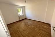 Günstige Starterwohnung in herrlicher Grünlage: praktische 1-Zimmerwohnung mit heller Wohnküche und separatem Schlafzimmer im kleinen Mehrparteienhaus – ideal für Singles, Studierende oder Pendler!